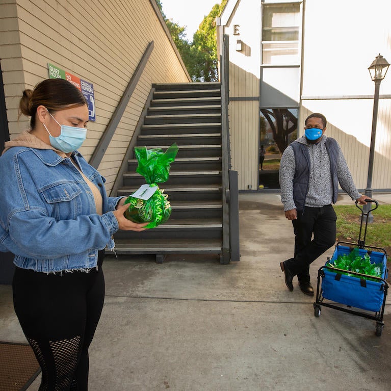 ennifer Guerra, 26, picked up a holiday care package from Guardian Scholars on Monday, December 14, 2020 at UC Riverside. (UCR/Stan Lim) 
